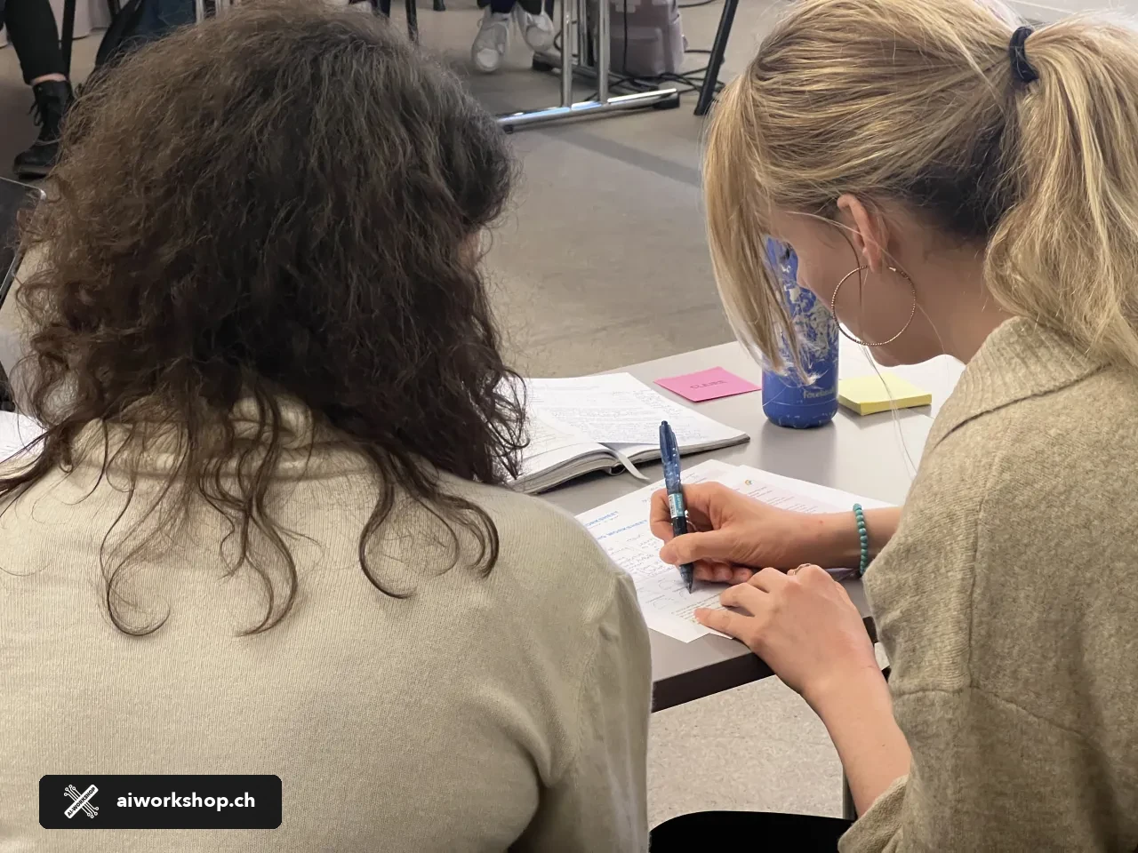 Participants working together during an AI Workshop session in Lausanne